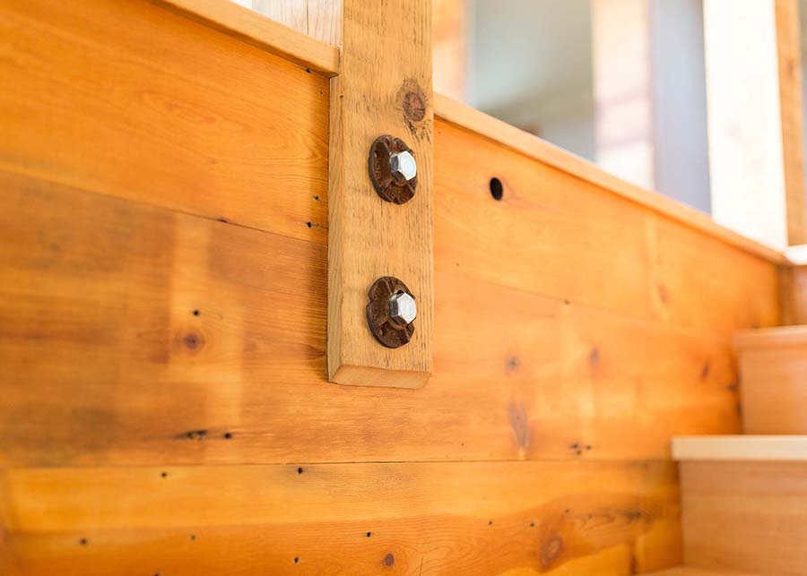 Close up of the bolted railings and reclaimed wood details on the home’s staircase